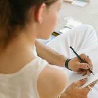 Portrait of a calm and focused woman, the guide of the practice.